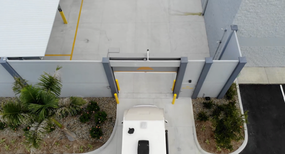 Figure 2: Concrete Barrier Wall Around Canopy Covered, Paved Outdoor Storage.